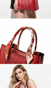 Dettaglio borsa rossa con goffratura floreale e manico avvolto in un foulard di seta