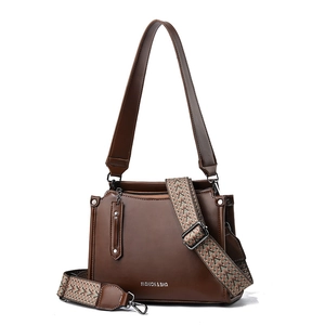 Brown leather women's shoulder bag with dual straps and ethnic geometric pattern