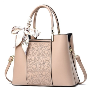 Elegant apricot embroidered handbag with floral texture and decorative silk scarf