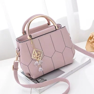 Pink PU leather handbag with geometric patterns and gold metal circular handle