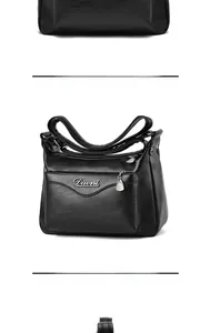 Detail view of black pebble leather bag with silver Davni logo and metallic zippers