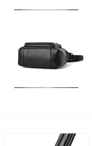 Detail shot of the wide bottom and textured synthetic leather on a black shoulder bag