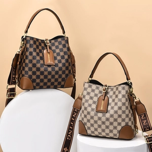 Retro checkerboard bucket bag with leather trim and wide adjustable shoulder strap