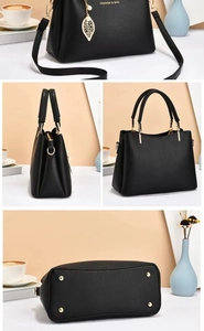 Détails du sac à main en cuir noir avec pendentif feuille dorée et clous de fond