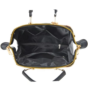 Detailed interior of large black floral handbag showing multiple storage compartments