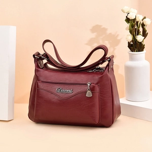 Elegant wine red leather shoulder bag for women with metallic Davni logo and dual straps