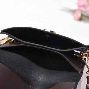 Detail view of the multi-layer interior and magnetic buckle of a vintage crossbody bag