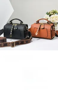 Detail of Boston handbags in black and brown with embossed logo and jacquard strap