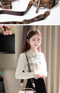 Detail of elegant small handbag featuring logo embossing and wide jacquard woven strap