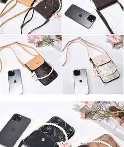 Detail of crossbody phone bag with pearl handle, floral pattern and bear pendant detail