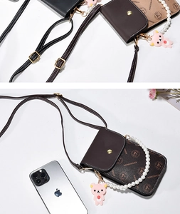 Detailed view of crossbody phone bag with pearl handle and cartoon bear charm