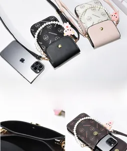 Detail view of mini crossbody bags with pearl handles and pink rabbit charms