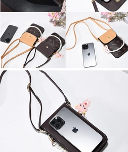 Detail of vintage patterned phone bag with pearl handle and cartoon bear pendant