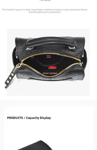 Detail view of the black leather handbag interior compartments with golden zippers