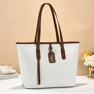 Minimalist large white tote bag with brown leather handles and lychee texture