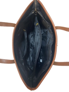 Interior view of brown leather tote bag with black fabric lining and functional zip pockets