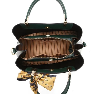 Interior detail of emerald tote bag featuring striped lining and organized compartments