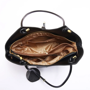 Detail view of large black tote bag interior with multiple compartments and golden lining