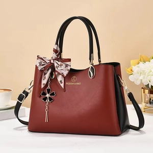 Elegant deep red and black contrast handbag with silk scarf and floral pendant