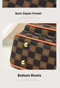 Detail of vintage patterned handbag featuring protective gold rivets and orange edge paint