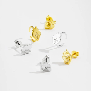 Macro shot of S925 sterling silver heart earrings with cross and flame design