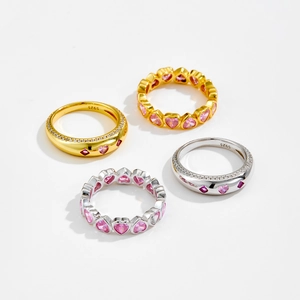 Macro shot of S925 silver heart rings with pink zircons and 18K gold plating