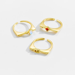 Three gold S925 adjustable open rings with colorful zircon stones on white background