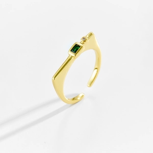 Detail of adjustable gold ring with rectangular green stone and tiny cubic zirconia