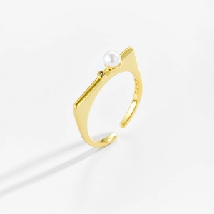 Macro view of gold S925 sterling silver cat ear ring with pearl and zircon inlay