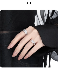 Dettaglio di anelli in argento S925 con texture lavica e bordi ondulati su modella