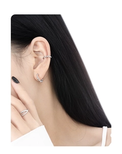 Close-up of S925 sterling silver chain earrings and textured ear cuff on model