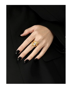 Detail of gold irregular lava texture ring with a rectangular cubic zirconia on a model