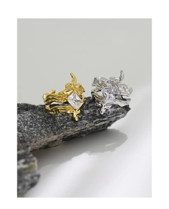 Detailed view of fluid texture silver and gold rings with rectangular zircon stones