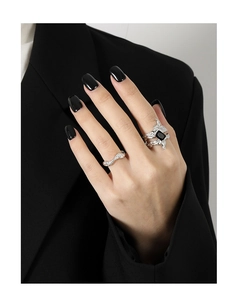 Detail of irregular textured silver ring with rectangular black zircon on model