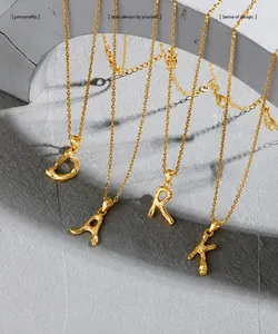 Detail of gold-plated S925 silver alphabet necklaces with irregular lava fluid design