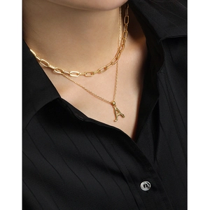 Double-layer gold S925 silver necklace with irregular letter A pendant on black shirt