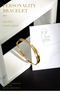 Minimalist gold open cuff bracelet displayed on an artistic marble base with elegant lighting