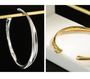 Detailed close-up of S925 sterling silver irregular wavy bangles in gold and silver finish