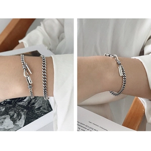 Close-up of vintage S925 sterling silver curb chain bracelet with rectangular tag
