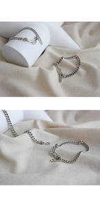 Macro detail of S925 sterling silver chain with vintage tag and hook clasp