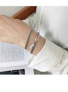 Macro shot of vintage S925 silver chain bracelet with rectangular pendant on a wrist