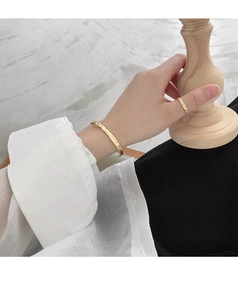 Detailed view of handmade gold hammered texture bangle and matching ring set
