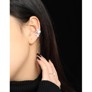Sparkling S925 silver clover ear cuff with zircon crystals worn by a model