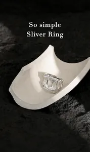 Macro detail of silver S925 irregular hollow ring with industrial texture on dark rock