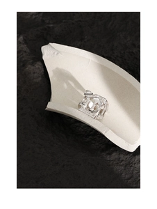 Macro detail of silver S925 ring with SOON engraving and irregular textured surface