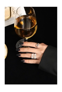 Detailed shot of an irregular hollow silver ring and double-layered minimalist band