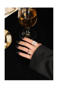 Close-up of hollow wide band and wavy S925 silver rings set on model fingers