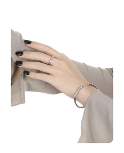Close-up of geometric square cut zircon stones on minimalist silver bangle and ring