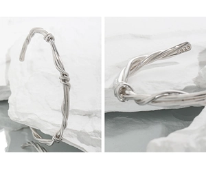 Detailed macro view of S925 sterling silver stamp on a twisted vine cuff bracelet