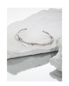 Detailed macro view of S925 sterling silver stamp on twisted minimalist vine cuff bracelet